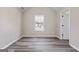 Bedroom with neutral walls, hardwood flooring, and window at 475 Louise Way, Locust Grove, GA 30248