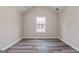 Bedroom with neutral walls, hardwood flooring and window at 475 Louise Way, Locust Grove, GA 30248