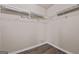 An organized closet with white racks and hardwood flooring at 475 Louise Way, Locust Grove, GA 30248