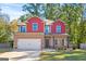 Inviting two-story home featuring a brick and red-sided facade, an attached two-car garage, and a well-manicured lawn at 475 Louise Way, Locust Grove, GA 30248