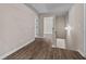 Hallway with wood-look flooring, fresh paint, and decorative shiplap at 475 Louise Way, Locust Grove, GA 30248