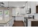 Open kitchen design with white cabinets, granite countertops, stainless steel appliances, and a subway tile backsplash at 475 Louise Way, Locust Grove, GA 30248