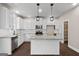 Modern kitchen featuring white cabinets, stainless steel appliances, granite countertops, and stylish pendant lighting at 475 Louise Way, Locust Grove, GA 30248