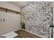 Laundry room with white painted brick accent wall, wooden shelf and neutral walls at 475 Louise Way, Locust Grove, GA 30248