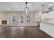 Sun-filled living area featuring a fireplace, large windows, and access to the kitchen with a central island at 475 Louise Way, Locust Grove, GA 30248