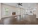 Open concept living room leading to the kitchen, featuring a fireplace and large windows for natural light at 475 Louise Way, Locust Grove, GA 30248