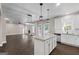 Open concept living space combines the kitchen and living room, with a cozy fireplace and ample natural light at 475 Louise Way, Locust Grove, GA 30248