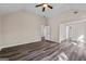Large main bedroom with vaulted ceiling, recessed lighting, wood-look flooring, and ensuite bathroom access at 475 Louise Way, Locust Grove, GA 30248