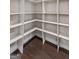 Walk-in pantry featuring custom shelving and wood-look flooring, offering ample storage space at 475 Louise Way, Locust Grove, GA 30248