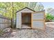Backyard storage shed with large open door for easy access at 475 Louise Way, Locust Grove, GA 30248
