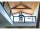 Bright foyer featuring wood ceiling and staircase with a modern chandelier at 4076 Airline Rd, Mcdonough, GA 30252
