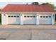 Detached three car garage featuring white doors with a red metal roof at 4076 Airline Rd, Mcdonough, GA 30252