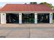 A spacious three-car garage with a red roof and open bays, revealing workshop and workout equipment at 4076 Airline Rd, Mcdonough, GA 30252