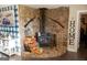 Rustic living room with stone fireplace, wood-burning stove, and antique decor at 4076 Airline Rd, Mcdonough, GA 30252