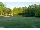 Scenic view of a tranquil pond surrounded by lush greenery, creating a peaceful atmosphere at 4076 Airline Rd, Mcdonough, GA 30252
