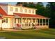 Inviting porch with rocking chairs and white railing, perfect for enjoying outdoor living at 4076 Airline Rd, Mcdonough, GA 30252
