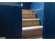 Unfinished wooden staircase between blue walls in a home under construction at 4076 Airline Rd, Mcdonough, GA 30252