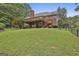 Expansive backyard with lush lawn and a spacious wooden deck with stairs at 135 Rockglen Ct, Fayetteville, GA 30215