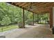 An outdoor deck with a ceiling fan overlooks a well-maintained backyard with privacy hedges and mature trees at 135 Rockglen Ct, Fayetteville, GA 30215