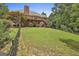 Large backyard with lush lawn and a wooden deck perfect for entertaining at 135 Rockglen Ct, Fayetteville, GA 30215