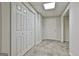 Hallway in basement area features tiled floors, closet space, and a door creating functional living at 135 Rockglen Ct, Fayetteville, GA 30215