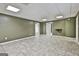 Open basement featuring tiled floors, light-colored walls, and white trim, offering a versatile living space at 135 Rockglen Ct, Fayetteville, GA 30215