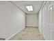 Basement area featuring tiled floors, neutral walls, and a closet, offering versatile living space at 135 Rockglen Ct, Fayetteville, GA 30215
