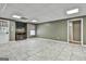 Finished basement with tiled floor, neutral walls, and entertainment area with an electric fireplace at 135 Rockglen Ct, Fayetteville, GA 30215