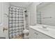 A full bathroom with a shower-tub combination, neutral-toned curtain, and single sink vanity at 135 Rockglen Ct, Fayetteville, GA 30215