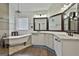 Elegant bathroom with a clawfoot tub, stylish vanity, and decorative mirrors at 135 Rockglen Ct, Fayetteville, GA 30215