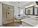Charming bathroom boasts a clawfoot tub, marble countertops, and a frameless glass shower at 135 Rockglen Ct, Fayetteville, GA 30215