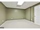Bedroom with neutral carpeting, light green walls, and a white door, offering a simple and clean design at 135 Rockglen Ct, Fayetteville, GA 30215