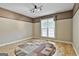 Cozy bedroom features a neutral color palette and a large window for natural light at 135 Rockglen Ct, Fayetteville, GA 30215