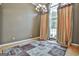 Formal dining room featuring large windows, elegant chandelier, and hardwood floors at 135 Rockglen Ct, Fayetteville, GA 30215