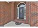 Elegant front door with decorative glass and brick surround, creating a welcoming entrance at 135 Rockglen Ct, Fayetteville, GA 30215