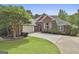 Charming brick home featuring a well-manicured lawn and a two-car garage at 135 Rockglen Ct, Fayetteville, GA 30215