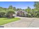 Attractive brick home with manicured lawn, two-car garage, and ample driveway space at 135 Rockglen Ct, Fayetteville, GA 30215
