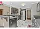 Kitchen features stainless steel appliances, black cabinets, and granite countertops at 135 Rockglen Ct, Fayetteville, GA 30215