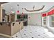 Eat-in kitchen featuring modern black cabinets, stainless steel appliances, and breakfast bar at 135 Rockglen Ct, Fayetteville, GA 30215