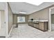 Finished basement featuring kitchenette with sink, window, and tiled floor offering convenience and versatility at 135 Rockglen Ct, Fayetteville, GA 30215