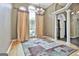 Open-concept living space with hardwood floors, large windows, and elegant lighting fixtures at 135 Rockglen Ct, Fayetteville, GA 30215