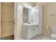 Bathroom showcases a white vanity with mirror, toilet, and a closet at 488 N Jeff Davis Dr, Fayetteville, GA 30214