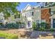 Exterior view of the townhomes with a beautiful landscaped yard, walkway, and a black fence at 488 N Jeff Davis Dr, Fayetteville, GA 30214