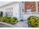 Inviting townhouse exterior with white siding, brick accents, and well-maintained landscaping at 488 N Jeff Davis Dr, Fayetteville, GA 30214