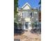 Close exterior of townhome with stucco finish, black shutters, and manicured front yard at 488 N Jeff Davis Dr, Fayetteville, GA 30214