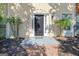 Charming entryway with covered porch, manicured landscaping, and brick walkway to front door at 488 N Jeff Davis Dr, Fayetteville, GA 30214