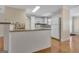 Well-lit kitchen featuring white cabinetry, tiled backsplash, modern appliances, and a breakfast bar at 488 N Jeff Davis Dr, Fayetteville, GA 30214