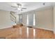 Spacious living room features hardwood floors, a ceiling fan, and stairs leading to the second floor at 488 N Jeff Davis Dr, Fayetteville, GA 30214