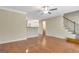 Open-concept living room featuring hardwood floors, staircase, and neutral paint at 488 N Jeff Davis Dr, Fayetteville, GA 30214