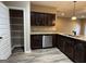 Modern kitchen featuring dark cabinetry, stainless appliances and pantry at 1853 Broad River Rd, Atlanta, GA 30349